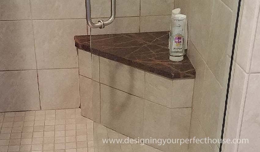 Pretty marble floating bench in shower.