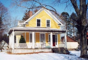 Typical Gable-Front and Wing home featuring wrap porch.  this style does not typically feature a front balcony over the porch roof.